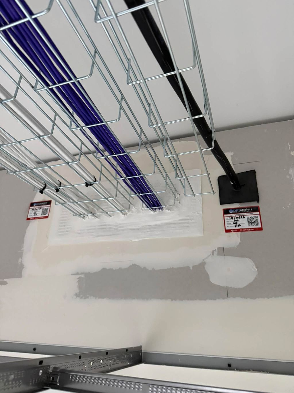 Sealed cable basket penetration with DP Interiors labels